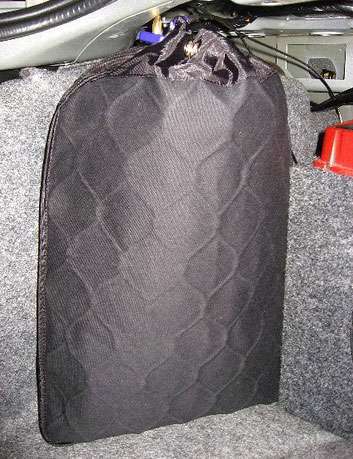 Portable lravel safe securing a laptop in a vehicle trunk.
